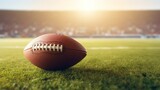 Fototapeta Sport - American football ball on the grass of a stadium