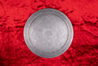 © serikbaib - ancient round silver shield on a red background