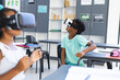 © Wavebreak Media - Biracial boy and girl are exploring virtual reality in a classroom in school