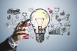 © Who is Danny - Close up of businessman hand drawing creative business sketch with huge light bulb and other icons. Idea, innovation and financial growth concept.