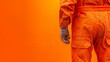 © zainab - A man in an orange jumpsuit stands defiantly against a vibrant orange wall