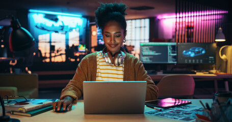 Fototapete - Portrait of a Black Smiling Female, Using Laptop Computer, Smiling in a Creative Office. Empowered Information Technology Specialist and Developer Working on a Project