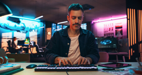 Aufkleber - Portrait of a Young Man Typing on Keyboard and Working on Desktop Computer in a Creative Office with Neon Lights. Male Software Developer Writing Code. Point of View of Screen Monitor 