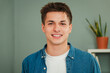 © Jose Calsina - Close up individual portrait of one young adult caucasian guy smiling and looking at camera with friendly expression. Headshot of a real teenage man student with white teeth staring front at home