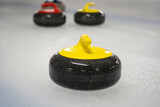 Fototapeta Mapy - Curling stones, used to play the game of curling. Polished and shaped granite rocks with a handle on top, for players to slide across the ice sheet surface towards a target circle area or the house.