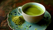 A cup of matcha green tea accompanied by a portion of matcha powder.