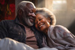 An elderly dark-skinned man and woman lay side by side in bed, expressing love and connection