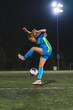 © PoppyPix - young girl wearing a blue uniform playing with a ball at an evening practice, athlete kids concept. High quality photo