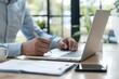 © ttonaorh - Close-up of Businessman working with financial data report and laptop computer in modern office