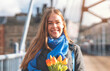 Portrait of happy woman with tulips  having a fun day, walking around an English city Lifestyle, tourism,  world woman's day concept