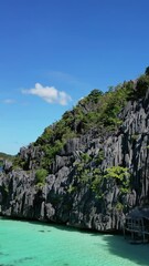 Wall Mural - aerial view of tropical philippines island. white sand beach, rocks cliffs mountains with blue bay a