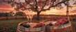 In a vineyard at sunset, wine glasses and bottles rest on a barrel.