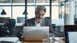 © john - Middle aged professional business man ceo investor working online looking at computer in office. Busy older mature businessman executive or entrepreneur wearing suit sitting at desk using laptop.