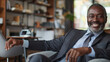 © VK Studio - Charismatic businessman with a beaming smile in a stylish office.