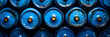 Pattern of Blue Propane Tanks Tightly Packed,
lined up plastic big bottles or blue gallons of purified drinking water inside the production line.