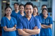 Cheerful Asian Male Nurse Leading Diverse Medical Team in Modern Clinic