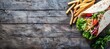 © Ilja - Top view of traditional wraps and french fries on wooden table with space for text