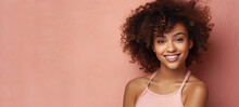 Cute Young Black Woman With Curly Hair  Wearing A Pink Tank Top, Smiling Isolated Pink Background