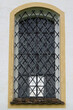 Church window in Germany, barred with a wrought iron grille