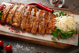 Fototapeta Tulipany - Close up of grilled ribs on wooden platter food