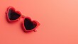 © Татьяна Макарова - Red heart-shaped sunglasses resting on a matching red backdrop