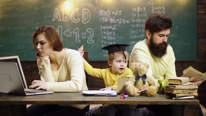 Fototapete - The family school. Parents teaching children. Family in early development concept. Father mother and child son painting together at home.