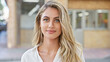 © Krakenimages.com - Cool, relaxed young blonde woman seriously looking at camera, standing casually in sunny urban street, attractive lifestyle portrait, outdoors with city background