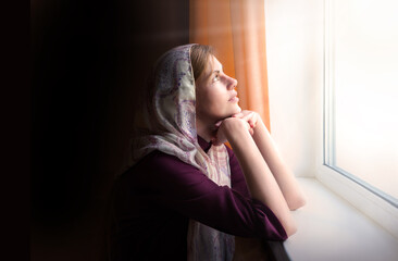 Wall Mural - Girl praying by the window