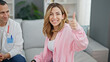 © Krakenimages.com - Man and woman doctor and patient writing medical report doing thumb up gesture at the clinic