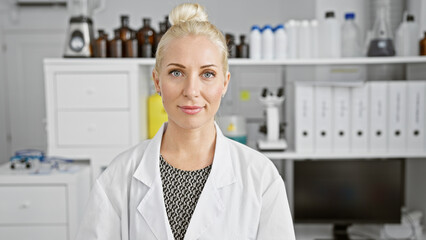 Poster - Happy young blonde woman scientist confidently standing, smiling while working on research in lab