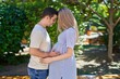 © Krakenimages.com - Man and woman couple standing together touching belly at park