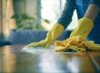 Cleaning home table sanitizing kitchen table surface with disinfectant spray bottle washing surfaces with towel and gloves. COVID-19 prevention sanitizing inside.