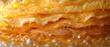Close-up of pancakes edge with golden syrup pouring and bubbling. Horizontal banner 7:3