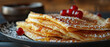 Folded pancakes with red berries on the plate on the wooden table. Horizontal banner 7:3