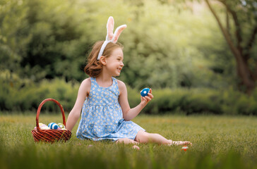 Sticker - child with painting eggs outdoors