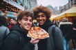 Happy young gay friends are walking around the city and enjoying fresh delicious pizza