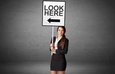 business person holding a traffic sign