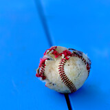 Fototapeta Las - Closeup of Old Worn Ragged Baseball Torn Cover for Sport