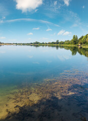 Wall Mural - Picturesque summer background lake bottom with algae. Concept of tranquil country life, eco friendly tourism, camping, fishing.