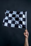 Fototapeta  - Checkered flag in hand. Racing, the concept of start, finish