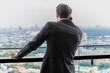 © Jack Tamrong - Portrait back view businessman talking on smartphone looking at city view from high rise office balcony
