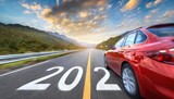 Fototapeta Tulipany - Blurred motion highway with red car, and new year number 2024, on the road 