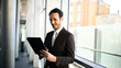 © Minerva Studio - Professional businessman using tablet outdoors