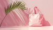 Pink tote bag with a palm leaf shadow on pink background