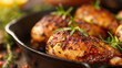 Close-up of succulent herb-crusted chicken breasts garnished with rosemary, served in a cast iron skillet