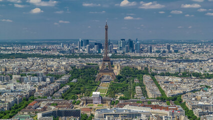 Wall Mural - Aerial view from Montparnasse tower with Eiffel tower and La Defense district on background timelapse in Paris, France.