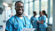 © MP Studio - smiling male healthcare professional in blue scrubs with glasses and a stethoscope