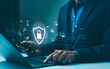 © Supatman - Cyber security data protection concept. Professional using a laptop with virtual protective shield, depicting online data security and cyber protection. Encryption privacy, Personal information access