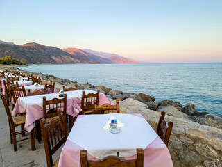Wall Mural - Outdoors traditional seaside taverna restaurant, Paleochora village afternoon in Crete island Greece