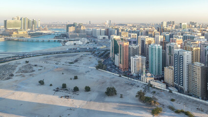 Wall Mural - Aerial skyline of Abu Dhabi city centre from above day to night timelapse